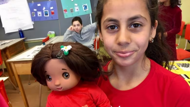 Refugee children in Sherbrooke receive custom-made doll who, like them, survived war